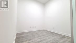 Markham (Unionville) condo for rent - A room with a wooden floor and white walls, with the text "HOMELIFE NEW.WORLD REALTY INC. Brokerage" on the bottom.
