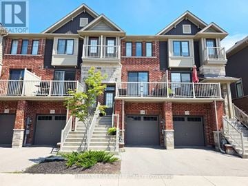 Hamilton townhouse for rent - A multi-story residential building with balconies and garages.
