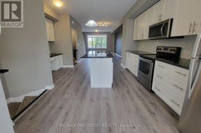 Hamilton townhouse for rent - A kitchen with a white countertop and a stainless steel refrigerator.