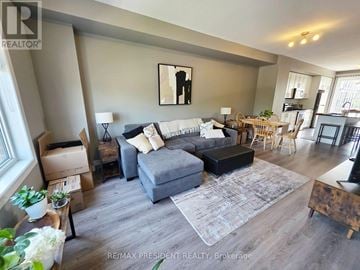 Hamilton townhouse for rent - A living room with a grey couch and a rug.