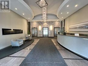 Toronto (Church-Yonge Corridor) condo for rent - A reception area with a grey carpet and a white sofa.