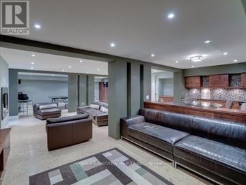 Toronto (St. Andrew-Windfields) apartment for rent - A living room with a brown leather couch and a rug.