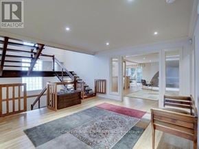 Toronto (St. Andrew-Windfields) apartment for rent - A spacious living room with a staircase and a rug.