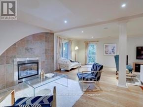 Toronto (St. Andrew-Windfields) apartment for rent - A living room with a fireplace and a glass coffee table.
