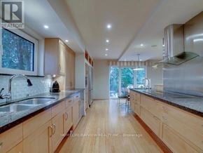 Toronto (St. Andrew-Windfields) apartment for rent - A modern kitchen with wooden cabinets and stainless steel appliances.