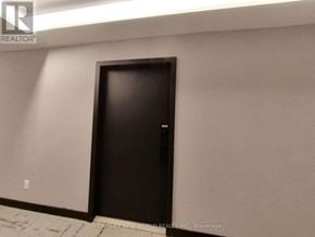 Toronto (North St. James Town) condo for rent - A black door in a room with a light on the ceiling.