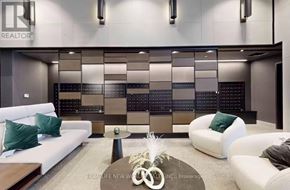 Markham (Unionville) condo for rent - A modern living room with a white sofa, a coffee table, and a large abstract wall art.