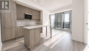 Markham (Unionville) condo for rent - A modern kitchen with a large island and a view of the city.