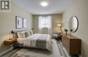London apartment for rent - A bedroom with a bed, nightstand, and chair.