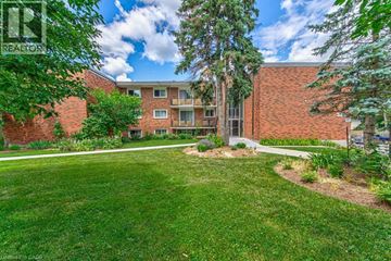 Waterloo apartment for rent - A well-maintained lawn in front of a brick building.