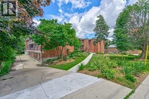 Waterloo apartment for rent - A residential area with a well-maintained lawn and a clear sky.