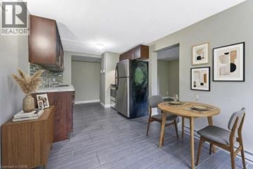 Waterloo apartment for rent - A kitchen with a table and chairs in the middle of the room.