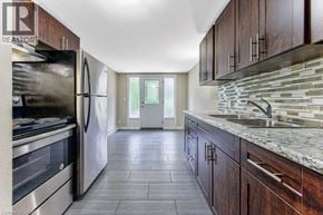 Waterloo apartment for rent - A kitchen with a refrigerator, sink, and cabinets.