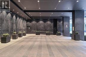 Toronto (Kensington-Chinatown) condo for rent - A lobby with a large wall mural and planters.