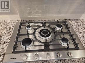 Toronto (Englemount-Lawrence) condo for rent - A stainless steel gas stove with four burners and a back control panel.