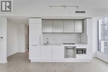 Toronto (Church-Yonge Corridor) condo for rent - A modern kitchen with white cabinets and appliances.