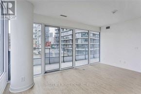 Toronto (Church-Yonge Corridor) condo for rent - A large empty room with a view of a city street through the windows.