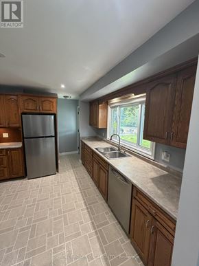 Haldimand apartment for rent - A kitchen with wooden cabinets and a tiled floor.