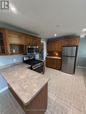 Haldimand apartment for rent - A kitchen with wooden cabinets and a granite countertop.