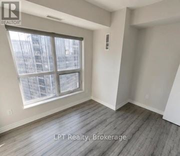 Toronto (Agincourt South-Malvern West) condo for rent - A room with a large window and wooden flooring.