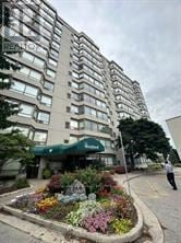 London South (South N) condo for rent - A large building with a green awning and a flower bed in front.