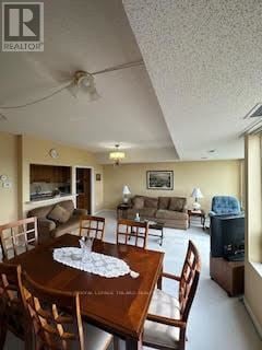 London South (South N) condo for rent - A living room with a wooden table and chairs.