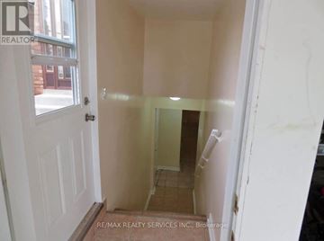Mississauga (Fairview) apartment for rent - A hallway with a door on the left and a wall on the right.