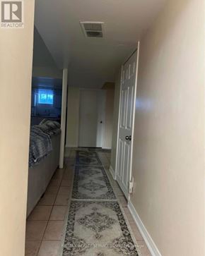 Mississauga (Fairview) apartment for rent - A hallway with a rug on the floor and a bedroom visible through the door.