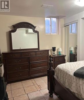 Mississauga (Fairview) apartment for rent - A bedroom with a large bed, a dresser, and a mirror.