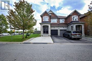 Brampton (Northwest Brampton) apartment for rent - A large house with a tree in front of it.