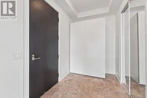 Toronto (Mimico) condo for rent - A room with a black door and white cupboards.