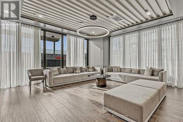 Toronto (Mimico) condo for rent - A spacious living room with a large sectional sofa and a coffee table.