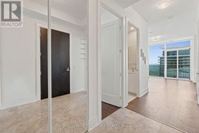 Toronto (Mimico) condo for rent - A room with a black door and a white door with a hallway in between.