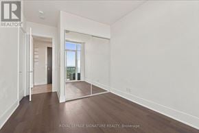 Toronto (Mimico) condo for rent - A room with white walls and wooden flooring, with a doorway leading to another room.