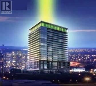 Mississauga (City Centre) condo for rent - A tall building with a green light on the top is shown in the image.