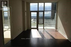 Mississauga (City Centre) condo for rent - A room with a view of the city through large windows.