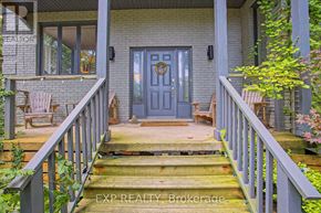 Grimsby (Grimsby West) apartment for rent - A house with a blue door and a wooden porch.