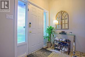 Grimsby (Grimsby West) apartment for rent - A white door with a glass window and a plant in front of it.