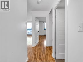 Windsor condo for rent - A hallway with wooden floors and white walls.
