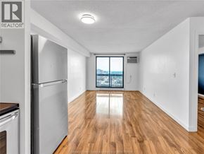 Windsor condo for rent - A spacious kitchen with wooden floors and a refrigerator.