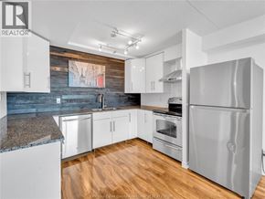 Windsor condo for rent - A kitchen with a refrigerator, oven, and cabinets.