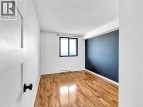 Windsor condo for rent - A room with a window and wooden flooring.