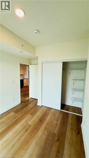Brantford condo for rent - A room with wood flooring and white walls.