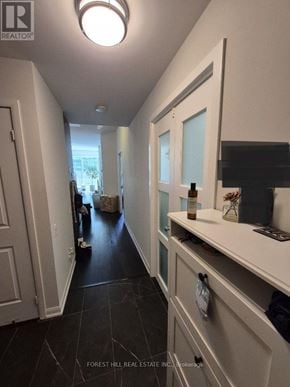 Toronto (Willowdale West) condo for rent - A hallway with a white door and a black floor.
