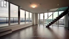 Toronto (Mount Pleasant West) condo for rent - A spacious room with a staircase leading to the upper level.