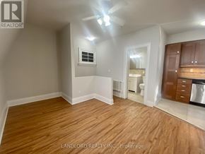 Toronto (Casa Loma) multi-family for rent - A room with wooden flooring and a ceiling fan.