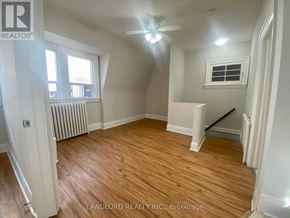 Toronto (Casa Loma) multi-family for rent - A room with wooden flooring and a ceiling fan.
