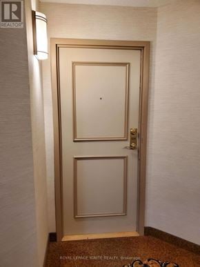 Toronto (Rouge) condo for rent - A white door with a gold frame and a gold doorknob.