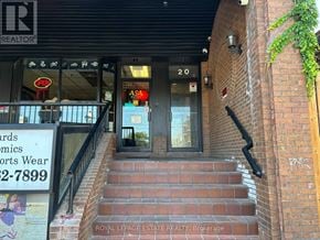 Toronto (Lambton Baby Point) multi-family for rent - A building with a sign that says "Royal LePage Estate Realty, Brokerage" on the stairs.