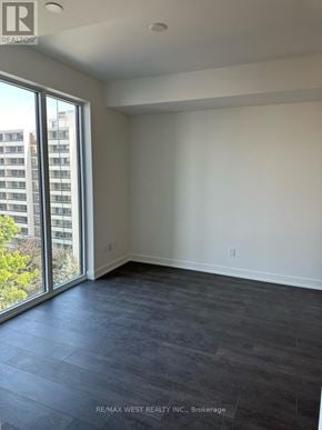 Burlington (Brant) condo for rent - A room with a large window and a view of a building outside.